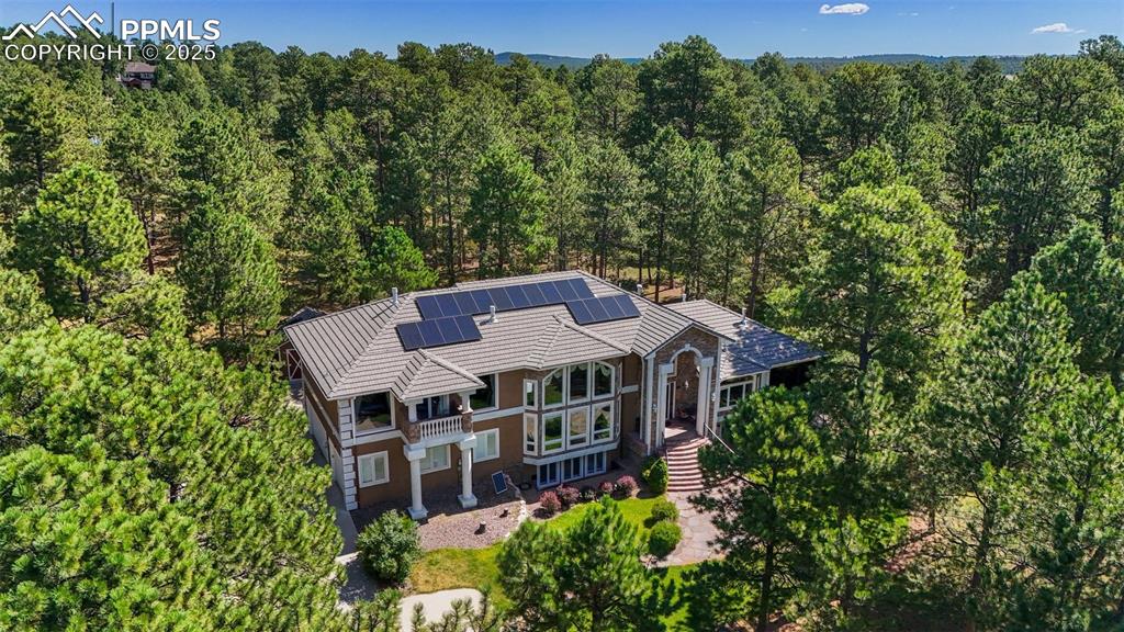Image 2 of 50: View from above of property featuring a heavily wooded area