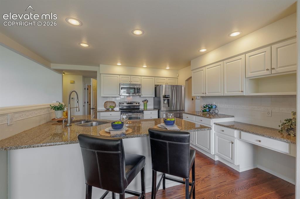 Image 10 of 41: Breakfast bar adjacent to the nook; large open and very functional kitchen
