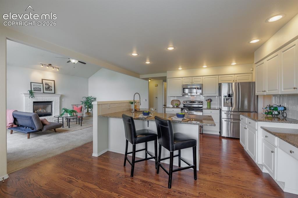 Image 12 of 41: Family room next to kitchen open and flowing plan