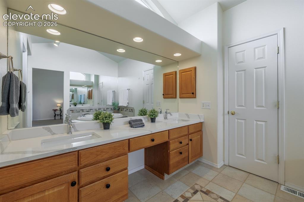 Image 22 of 41: Natural light pervades the primary spa-bathroom