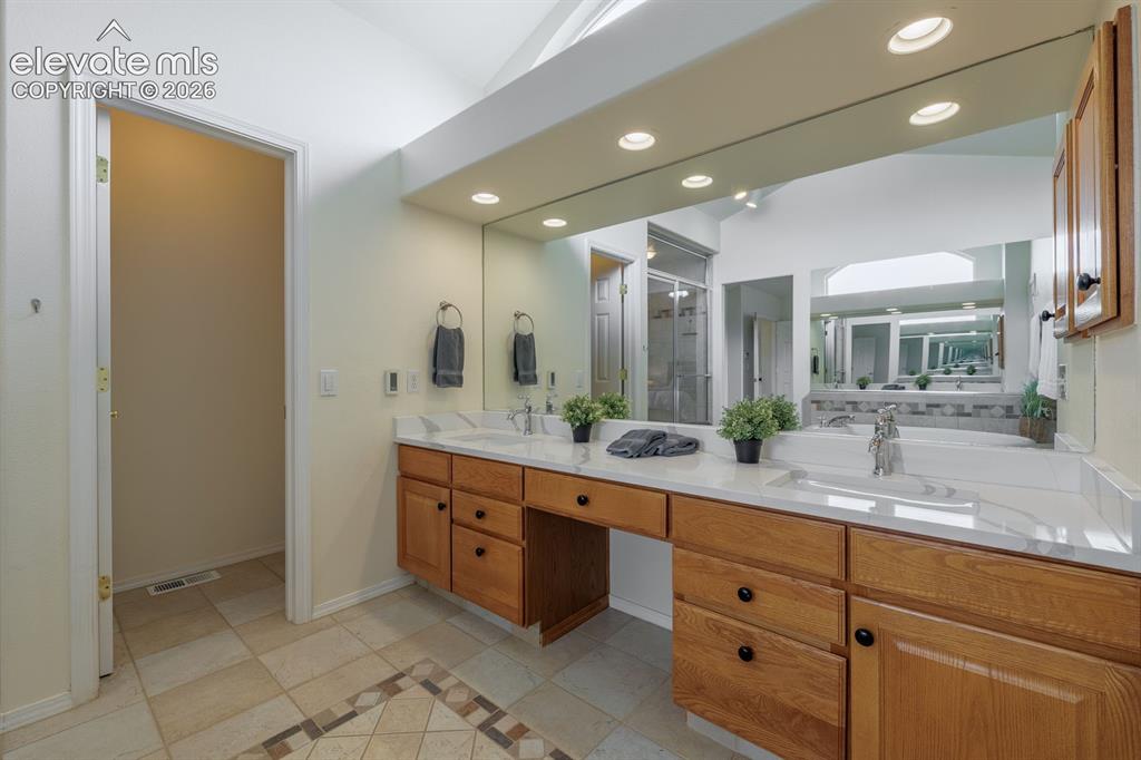 Image 24 of 41: Relax in the soaking tub. Spa like large shower with custom tile work