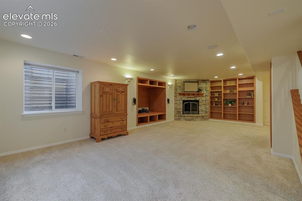 Image 29 of 41: Lovely custom wood bookcases in this large second family room; flex room of