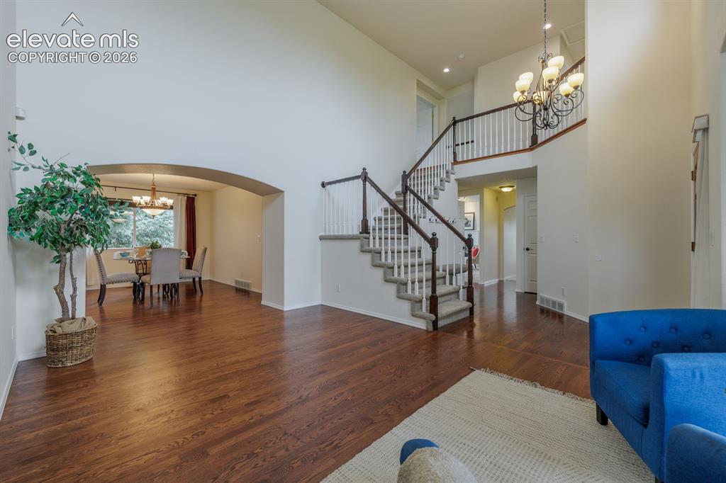 Image 3 of 41: Abundance of natural light and newer hardwood floors in living room off ent