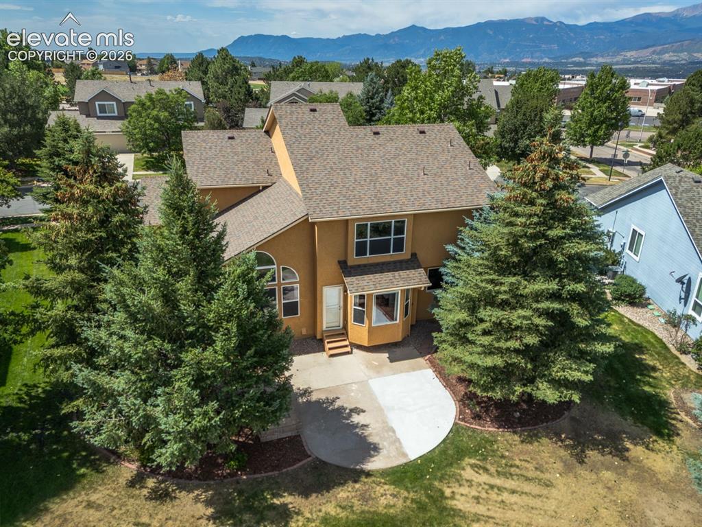 Image 39 of 41: Backing to open space very private yard with front range and Pikes Peak vie
