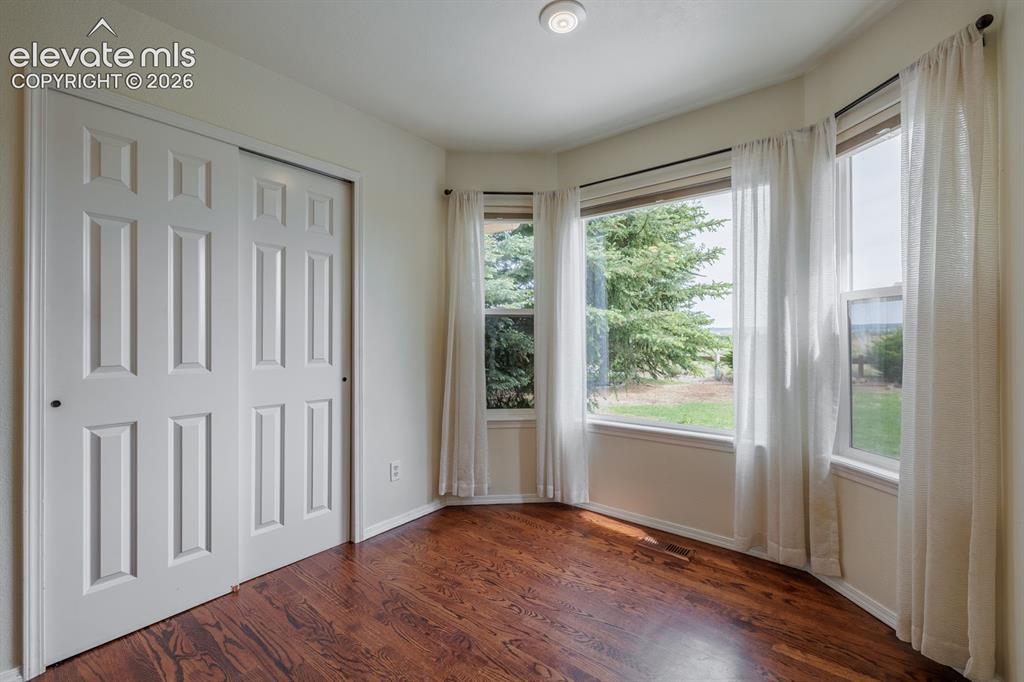 Image 9 of 41: Kitchen nook and large pantry with picture windows to private yard and open