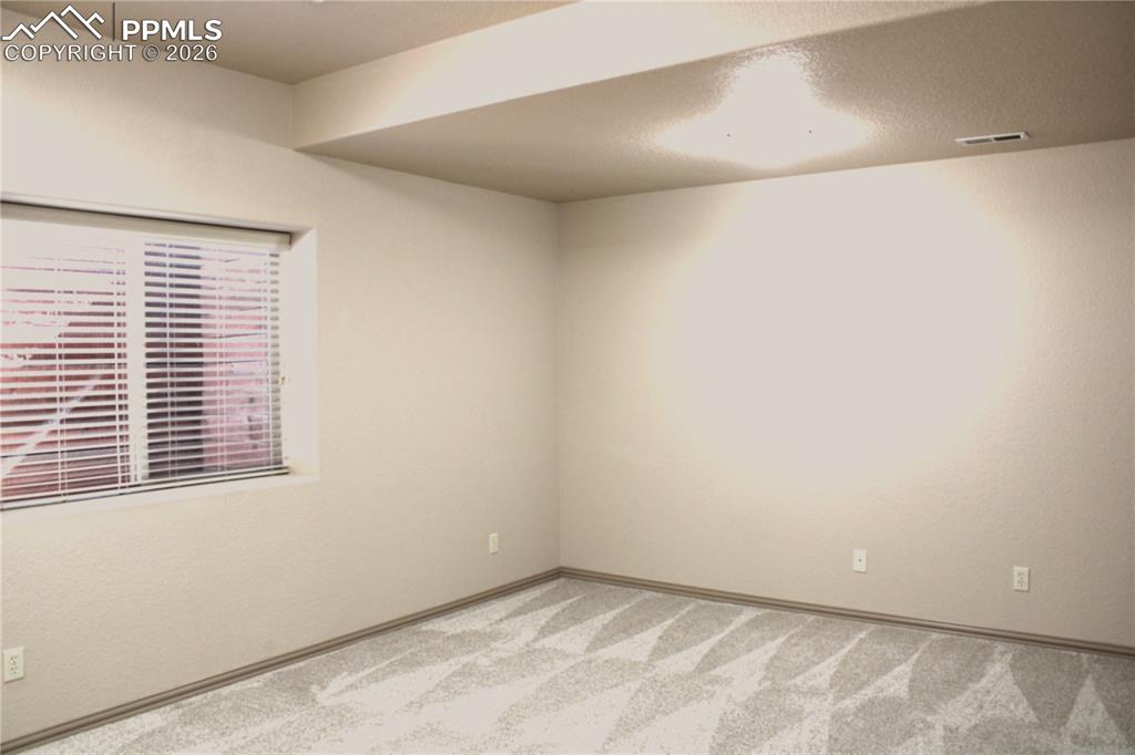 Image 29 of 49: Lower bedroom unfurnished