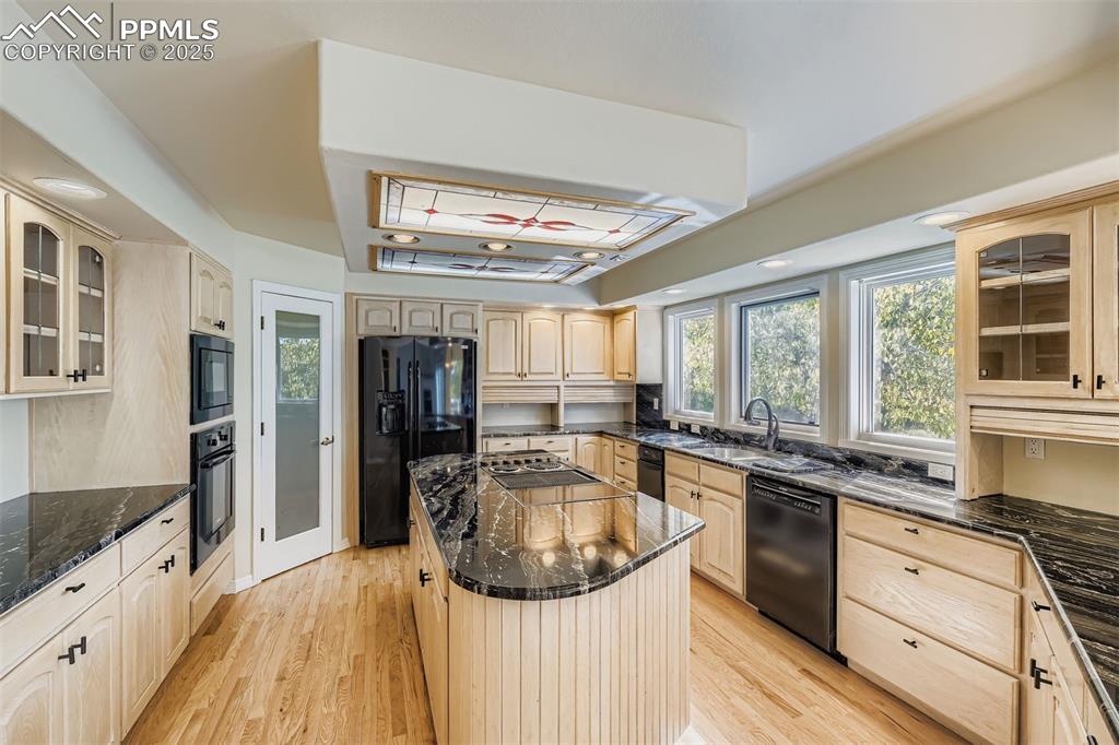 Image 10 of 35: Kitchen with Pantry, wooden cabinets, healthy amount of natural light, blac