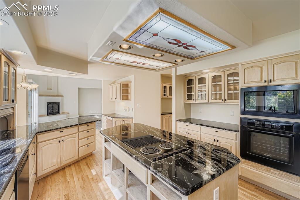 Image 11 of 35: Kitchen with Pantry, wooden cabinets, healthy amount of natural light, blac