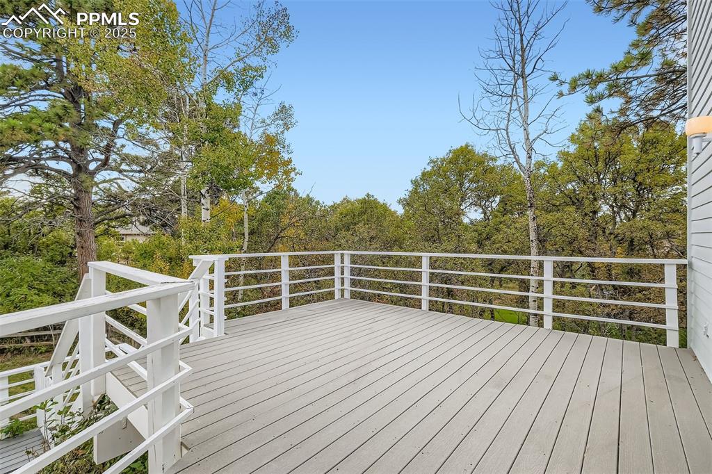 Image 16 of 35: Deck in the back (composite) with view of wooded area