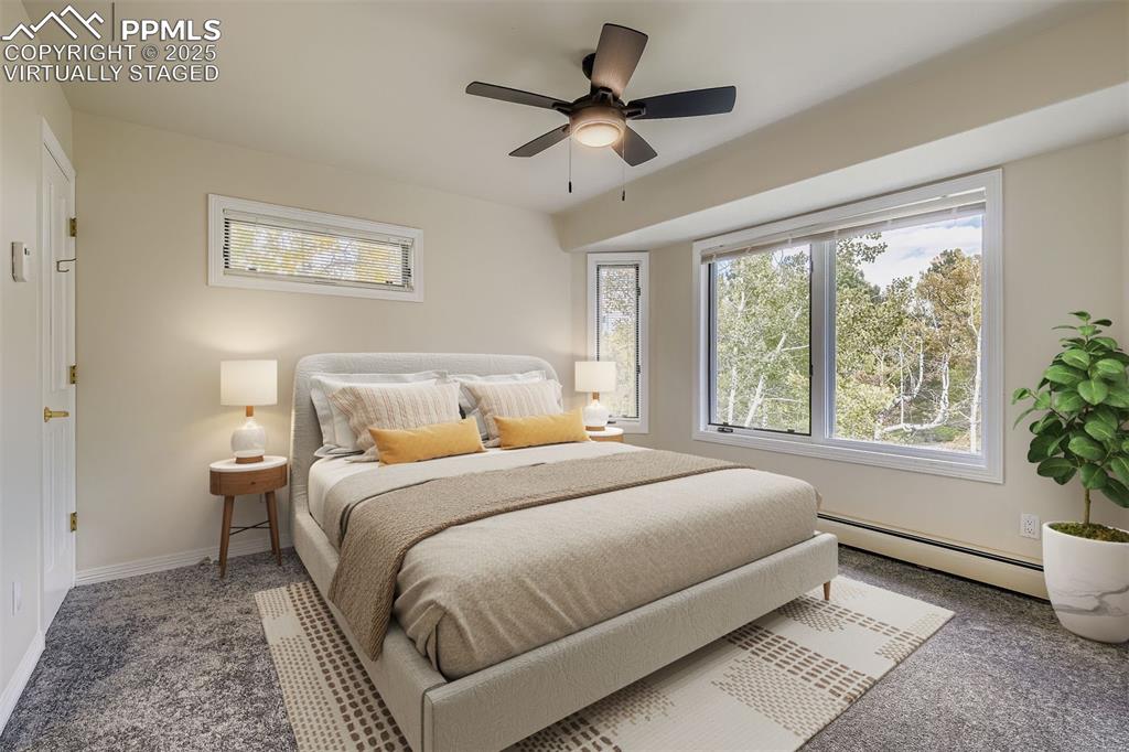 Image 23 of 35: Virtually Staged! Carpeted bedroom featuring a baseboard radiator, multiple