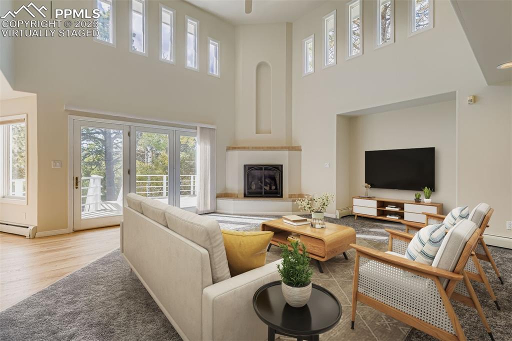 Image 3 of 35: Virtually Staged! Living room featuring a towering ceiling, a glass covered