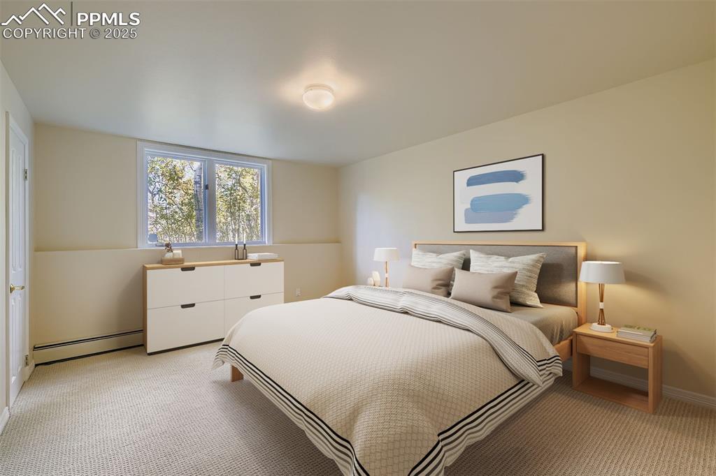 Image 32 of 35: Bedroom with a baseboard radiator and light colored carpet