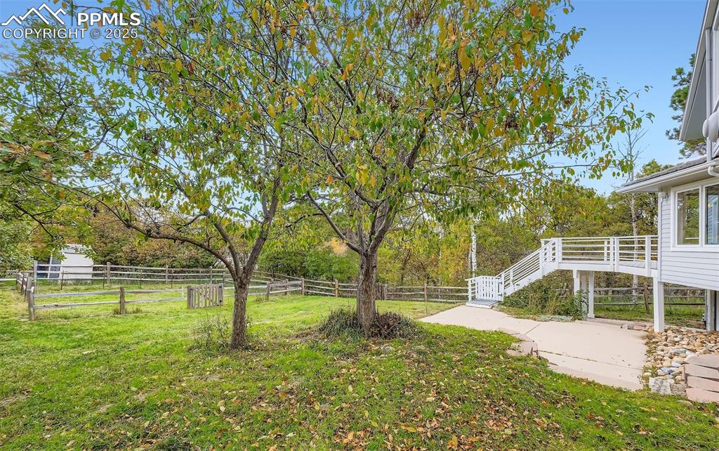 Image 34 of 35: Fenced backyard with stairway