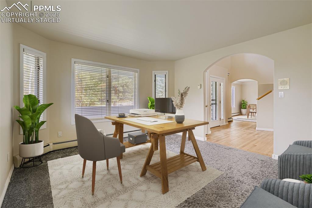 Image 8 of 35: Virtually Staged! Office featuring arched walkways and baseboard heating (m