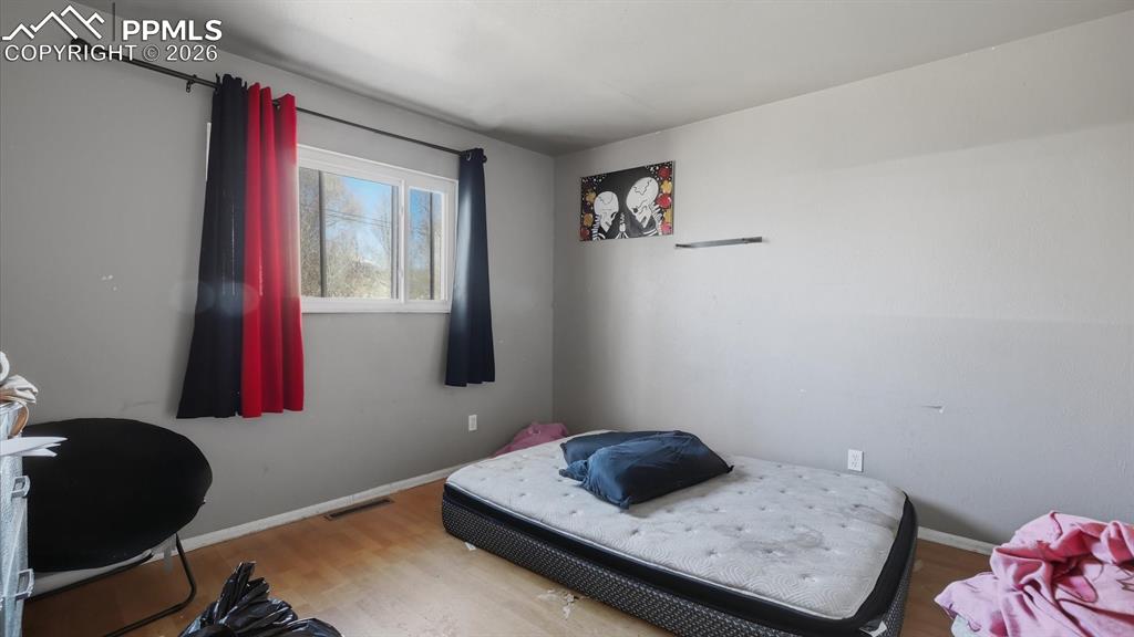 Image 14 of 30: Bedroom #2 has wood laminate flooring and window.