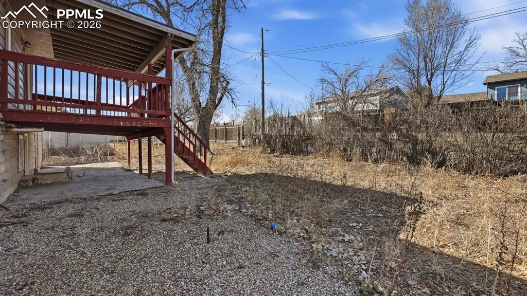 Image 26 of 30: Spacious fenced backyard ready for your dreams and imagination.