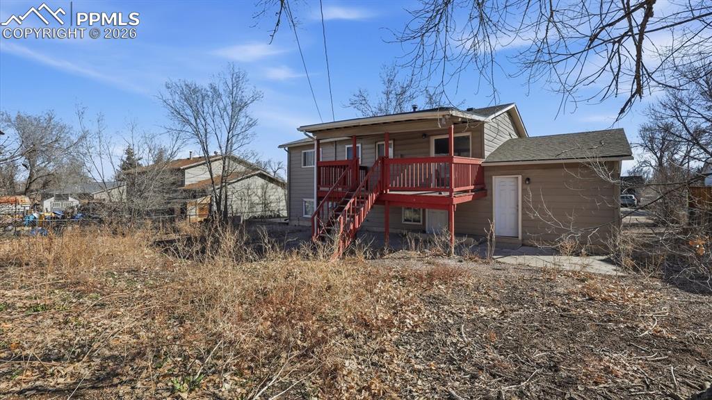 Image 27 of 30: Rear view of home and backyard.