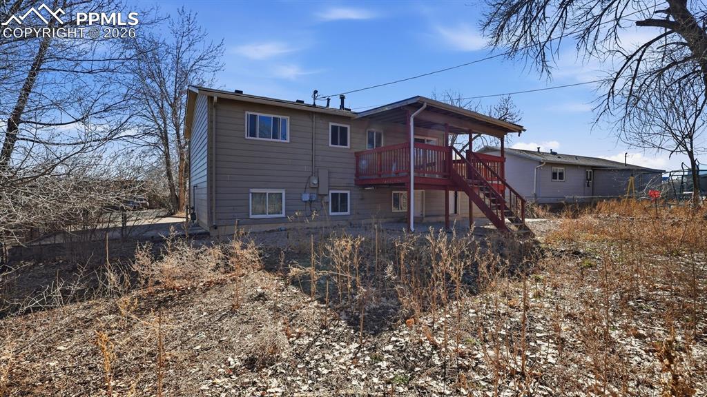 Image 29 of 30: Rear view of home and backyard.