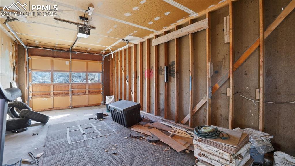 Image 30 of 30: Interior of 1-car attached garage with door opener.