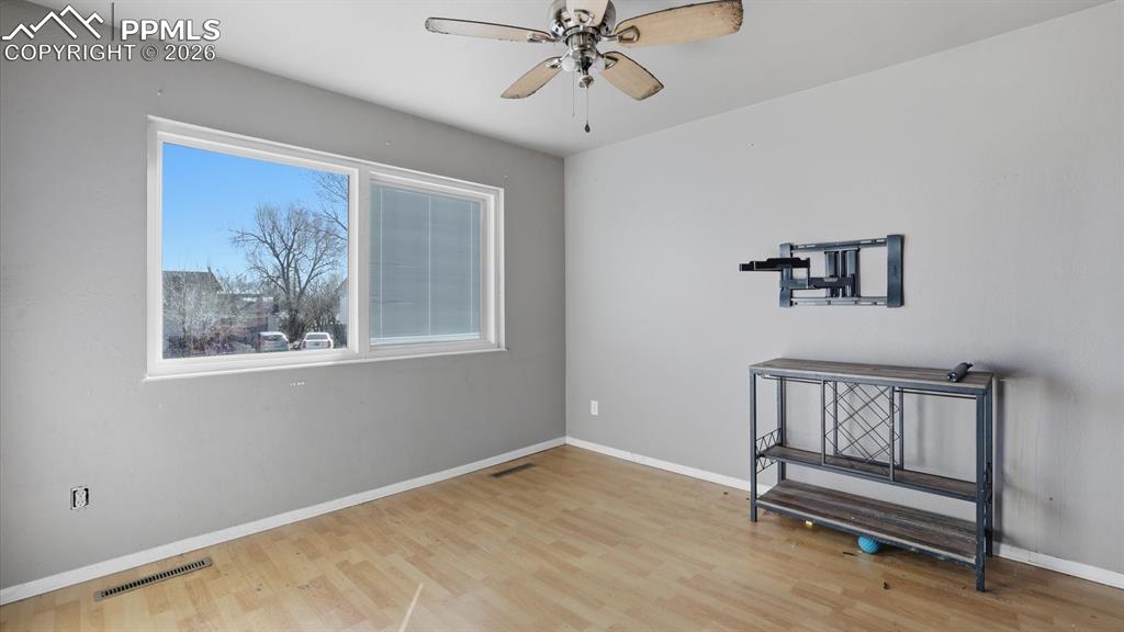 Image 4 of 30: The Living Room features wood laminate flooring, a lighted ceiling fan, and