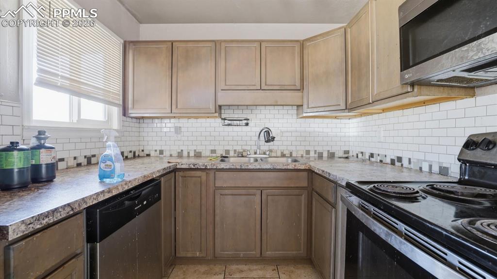 Image 9 of 30: The Kitchen has ample wood cabinetry and counter space, along with an elect