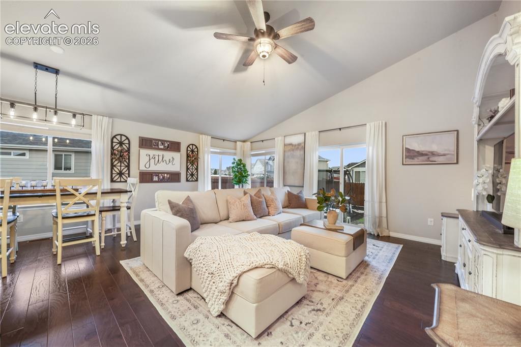 Image 11 of 50: Vaulted ceiling with an attached ceiling fan, rich wood-finish flooring, an