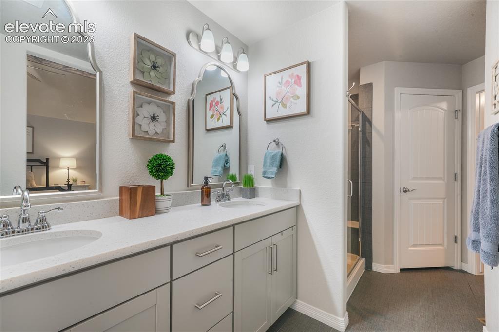 Image 18 of 50: Dual vanity with light-toned countertops and undermount sinks