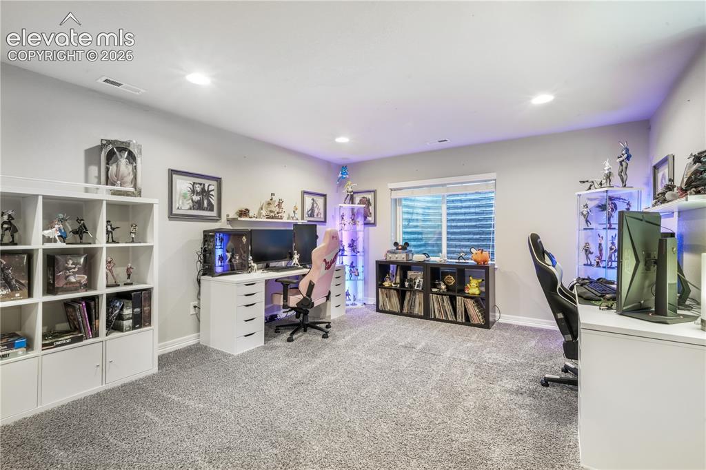 Image 28 of 50: Recessed ceiling lighting, light gray wall paint, and gray carpet flooring