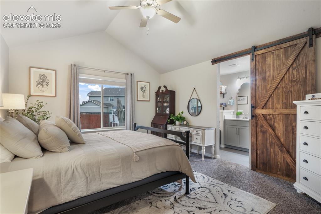 Image 4 of 50: Vaulted ceiling with ceiling fan, large window with blinds, wood-finish sli