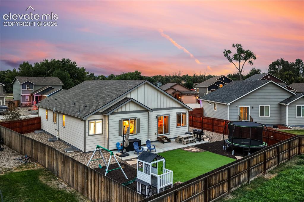Image 43 of 50: Exterior featuring a fenced backyard, an artificial turf lawn, and a concre
