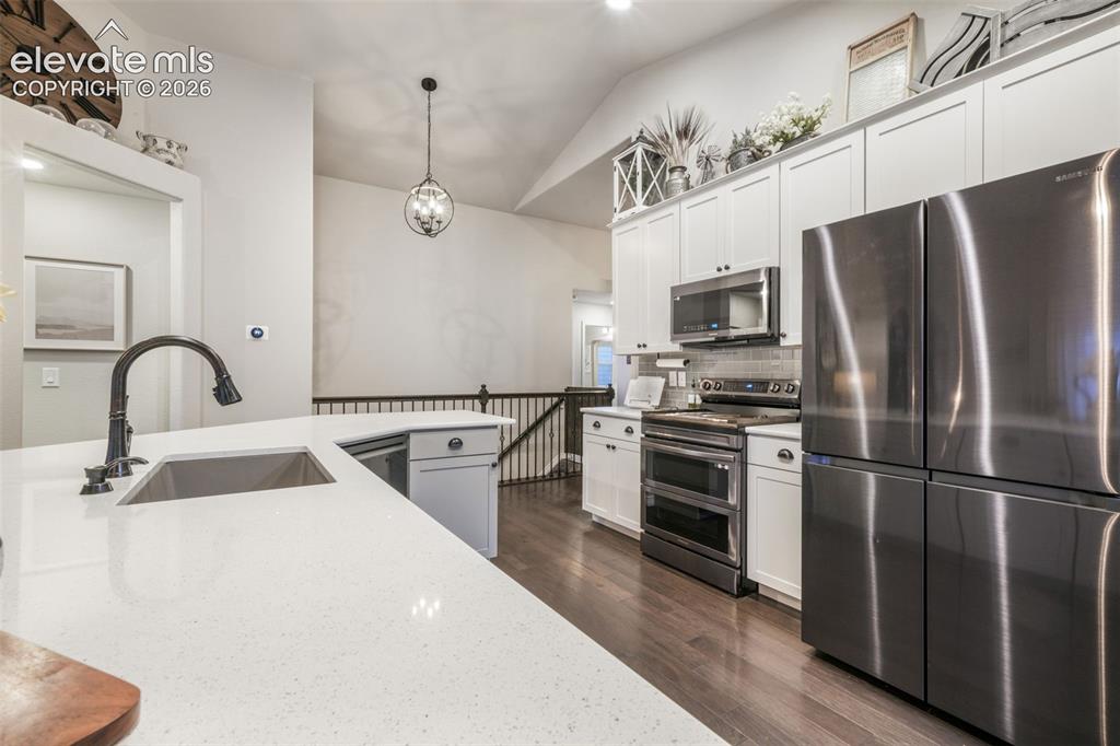 Image 5 of 50: Kitchen featuring white cabinetry, stainless steel appliances, a stainless