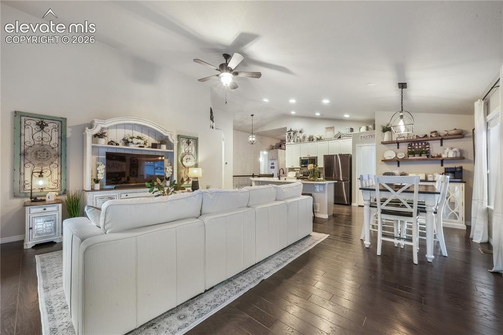 Image 8 of 50: Vaulted ceilings, wood-finish flooring, recessed lighting, and a ceiling fa