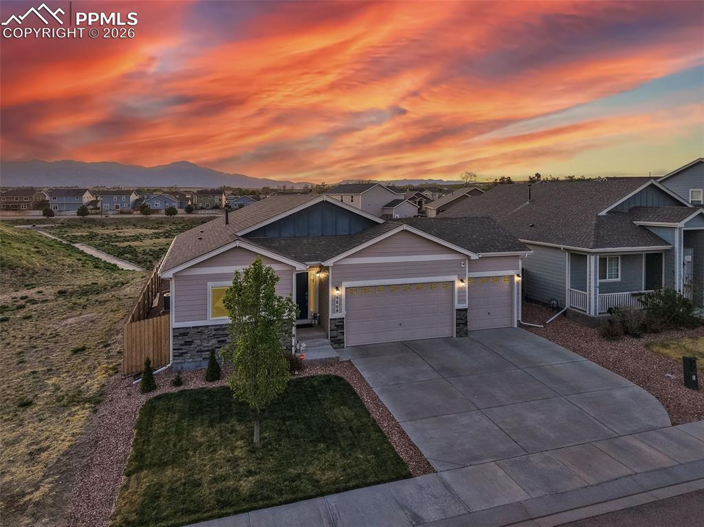 Caption: Welcome to this beautiful ranch-style home with stunning mountain sunset views!