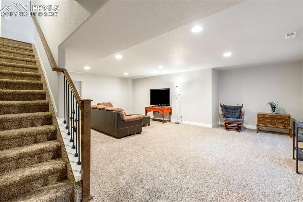 Image 18 of 28: Head downstairs to relax or entertain in the massive family room