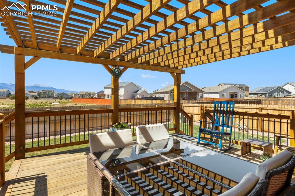 Image 22 of 28: The wood deck with pergola is the perfect place to sip your morning coffee 