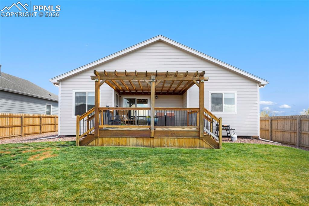 Image 24 of 28: The fully fenced yard is perfect for quiet evenings or entertaining with a 