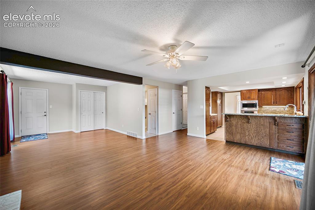 Image 20 of 50: Open Floor plan kitchen and family room. Door is leading to the garage.
