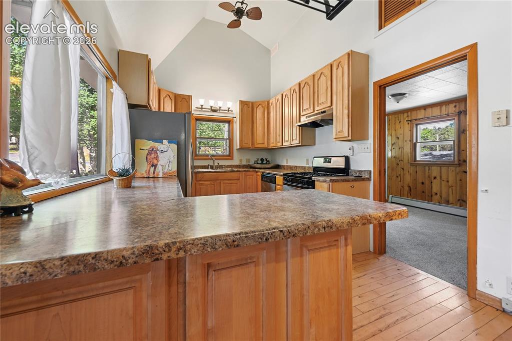 Image 10 of 45: Modernized kitchen with vaulted ceilings and lots of daylight. Non-conform