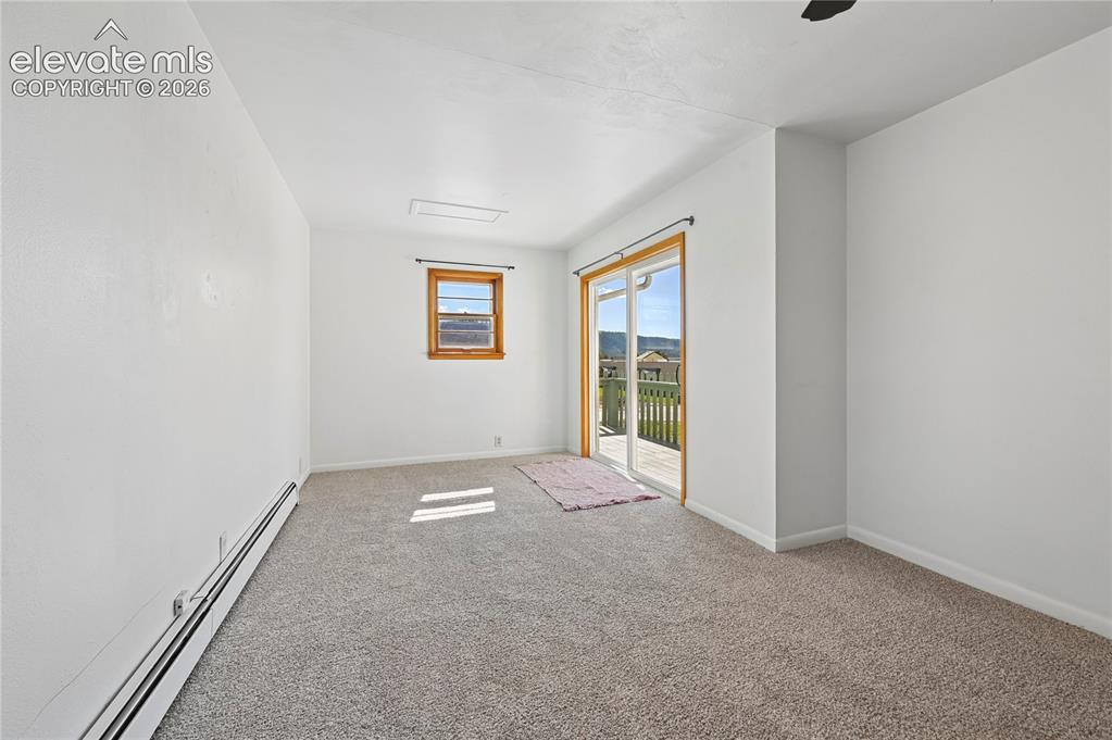 Image 13 of 45: Primary bedroom with new carpeting, mountain views, and bright clean paint.