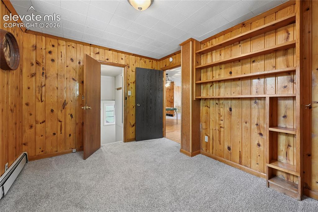Image 19 of 45: Bedroom/office #3 of 4 with a lockable door and stairs to the back door and