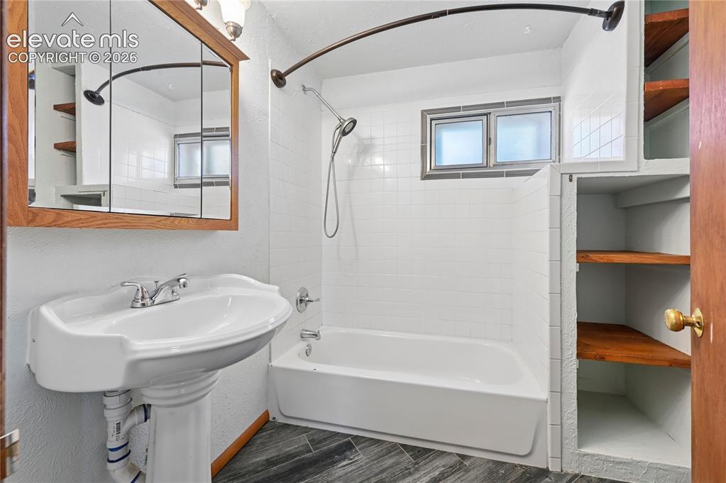 Image 20 of 45: Main level full bathroom with some updates and lots of storage for linens