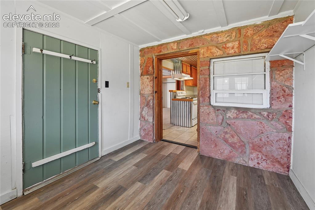Image 22 of 45: Lower level entrance room for coats, boots, dog leashes, and maybe some out