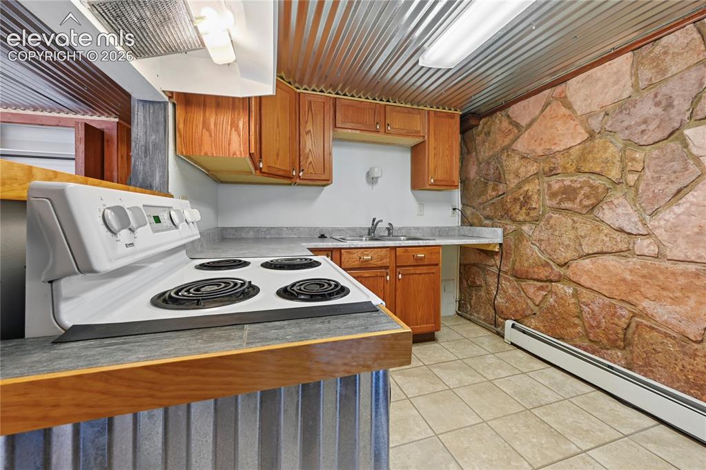 Image 24 of 45: Basement second kitchenette makes the two-level home wonderfully shareable