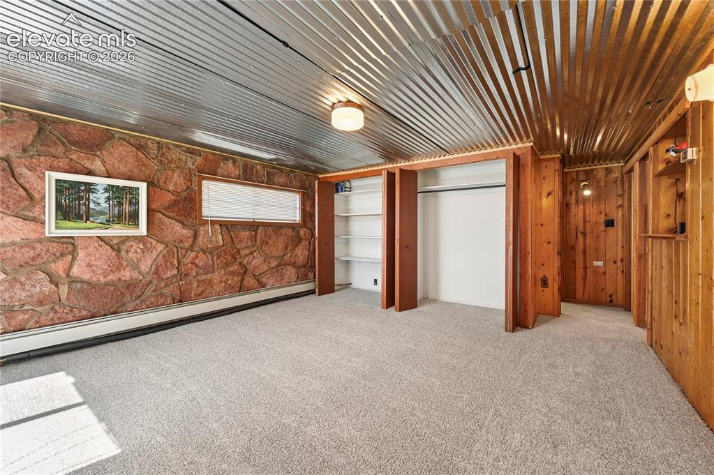 Image 27 of 45: Basement family room with extra closet storage space