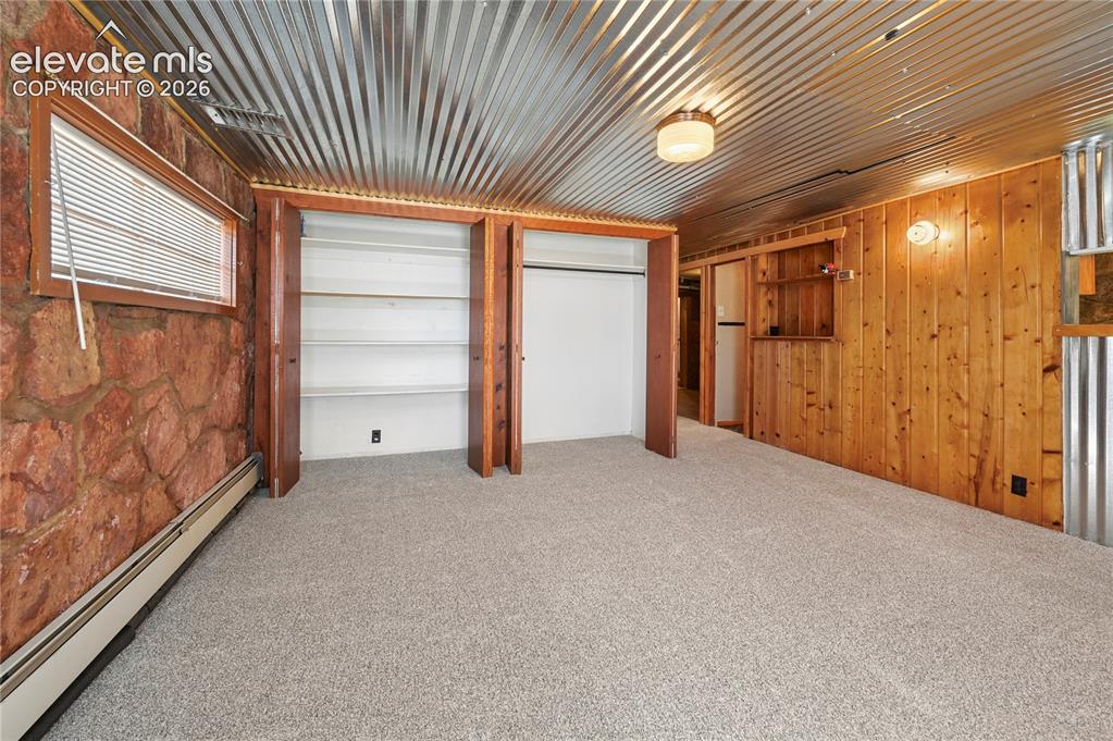 Image 28 of 45: Cozy basement family room with extra closet storage space, new carpeting, s