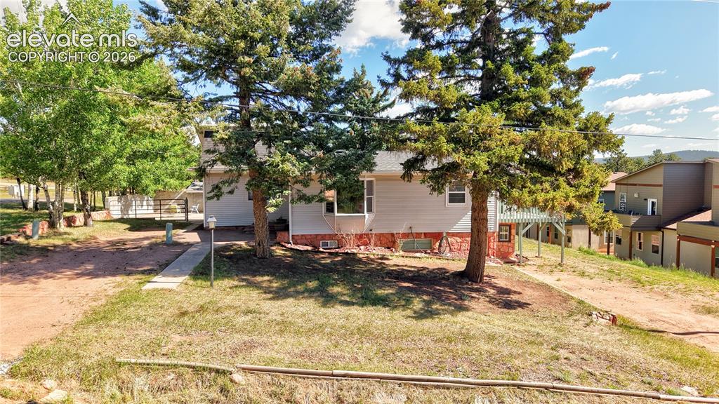 Image 3 of 45: Two driveways, two ground level entrances, and some lovely evergreen and as