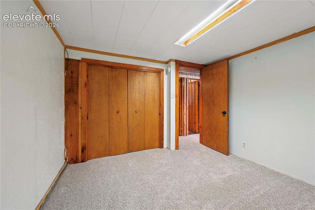Image 30 of 45: Basement bedroom is #4 in the home and makes the basement feel like its own