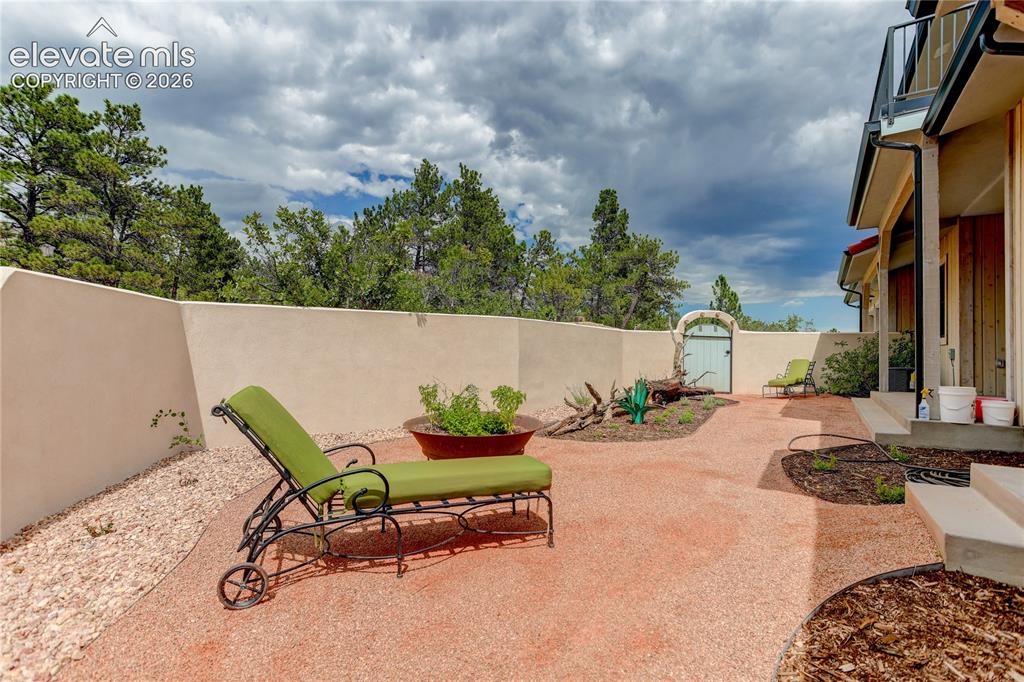 Image 35 of 46: Side patio off den & bedroom 4