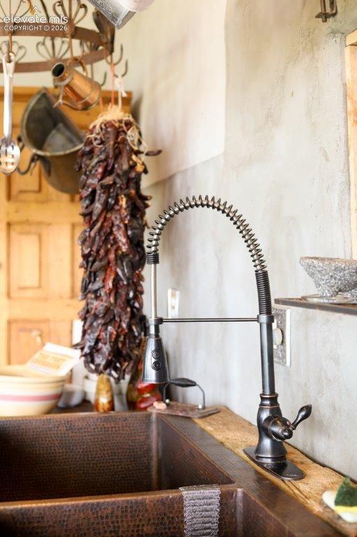 Image 11 of 50: Hammered copper double-basin sink with an oil-rubbed bronze high-arc pull-d