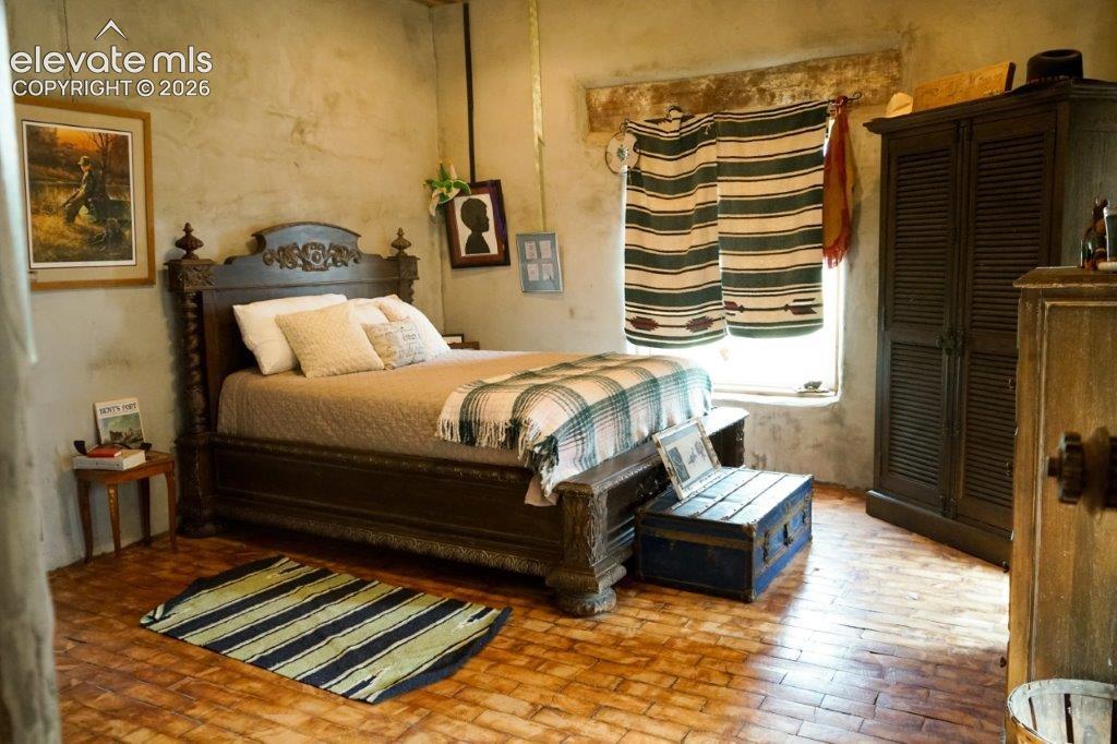 Image 36 of 50: Textured wall finishes with a window featuring horizontal striped curtains